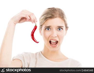 Beautiful girl making a silly face and holding a red chilli pepper, isolated over a white background