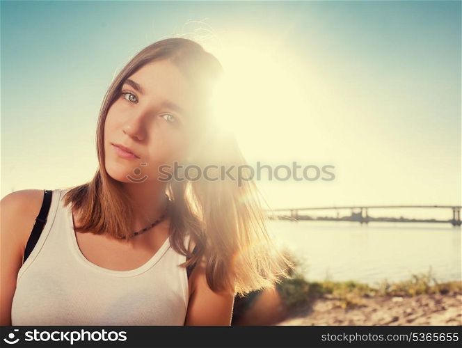 Beautiful girl on the beach alone. Blank expression on the face