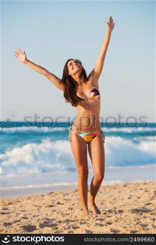 Beautiful girl on the beach wearing a bikini