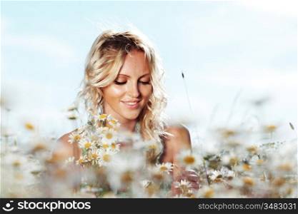 beautiful girl on the daisy flowers field