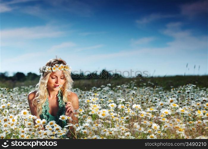 beautiful girl on the daisy flowers field