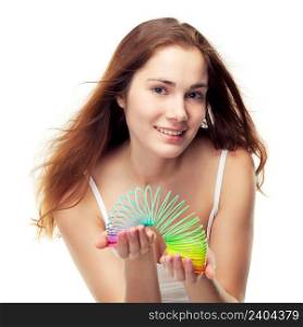 Beautiful girl playing with a colorful slinky. Can be concept of game, balance in diet etc, isolated on white