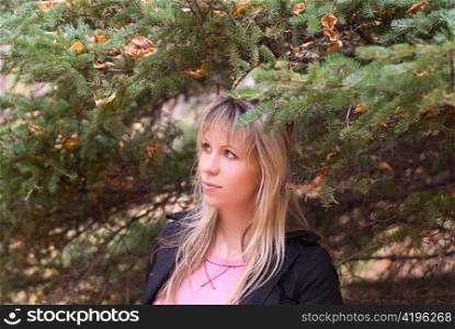 Beautiful girl portrait at autumn coniferous forest