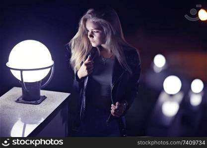 beautiful girl posing in the night city / model adult girl posing in the evening in the city, outdoor at night