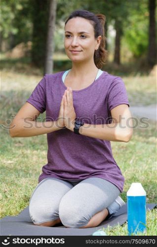 beautiful girl practices yoga in the morning forest