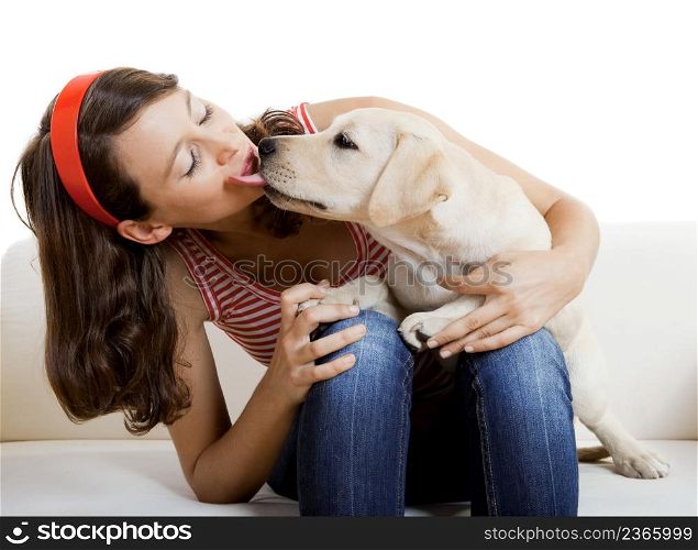 Beautiful girl receiving a kiss from her best friend, a nice and cute dog