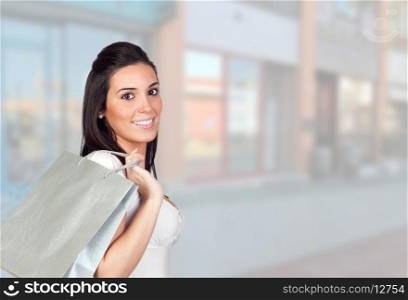 Beautiful girl shopping with bags on the street
