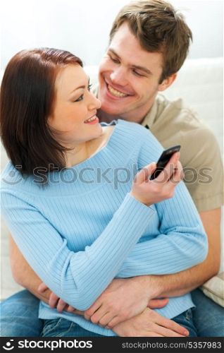 Beautiful girl showing something in cell phone to boyfriend