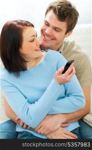 Beautiful girl showing something in cell phone to boyfriend