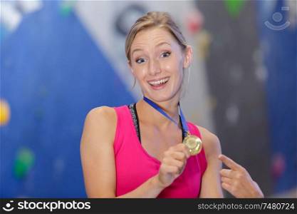 beautiful girl showing sports medals