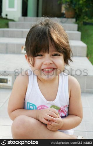 Beautiful girl sitting outdoors smiling