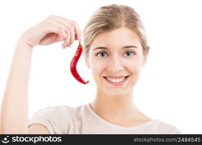 Beautiful girl smiling and holding a red chilli pepper, isolated over a white background