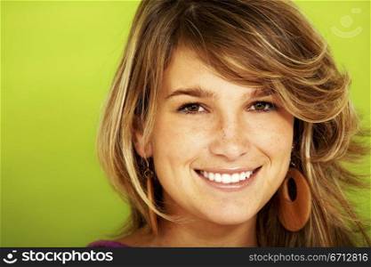 beautiful girl smiling over a green background