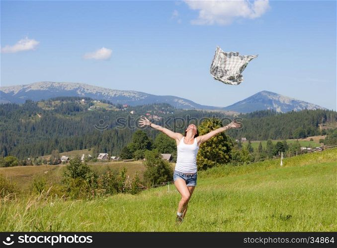 Beautiful girl throwing her clothes at grass meadow