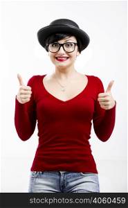 Beautiful girl wearing a hat and nerd glasses and thumbs up, isolated on white
