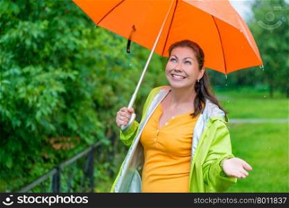 beautiful girl with a bright orange umbrella