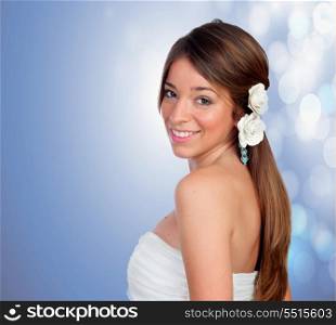 Beautiful girl with a flower on the head on a blue background with lights