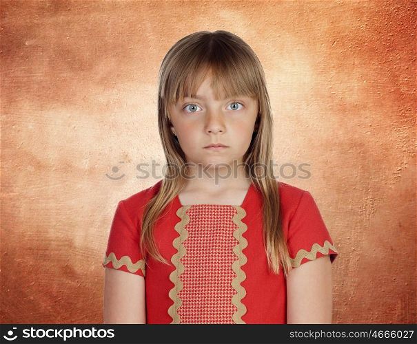 Beautiful girl with blond hair very angry on a orange background