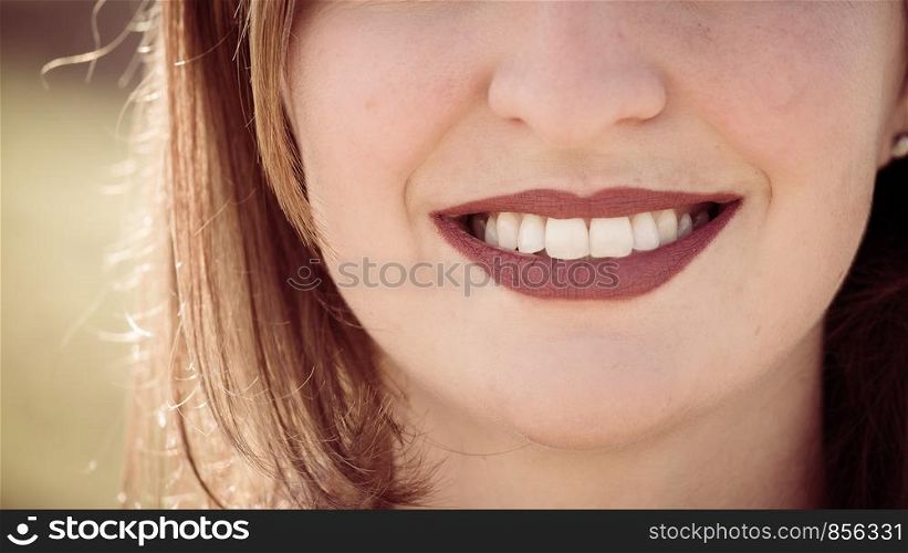 Beautiful girl with cherry red lips and white teeth is smiling