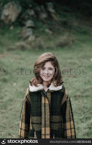 Beautiful girl with coat in the park at winter