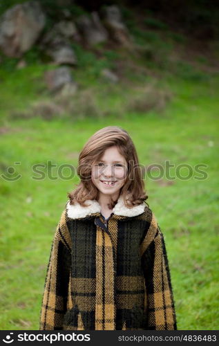 Beautiful girl with coat in the park at winter