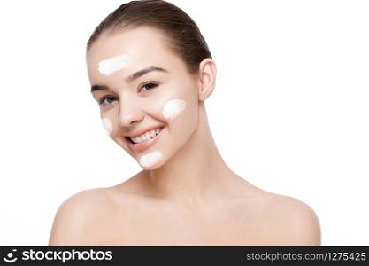 Beautiful girl with face cream natural makeup portrait on white background