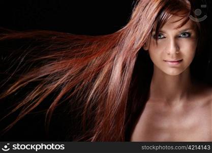 Beautiful girl with flowing hair on a black background