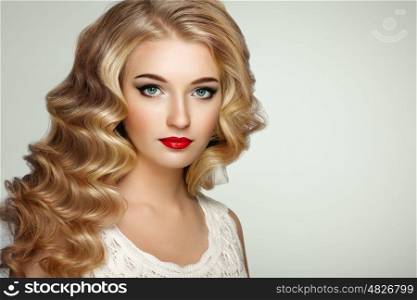 Beautiful girl with long wavy and shiny hair . Blonde woman with curly hairstyle. Perfect make-up. Fashion photo
