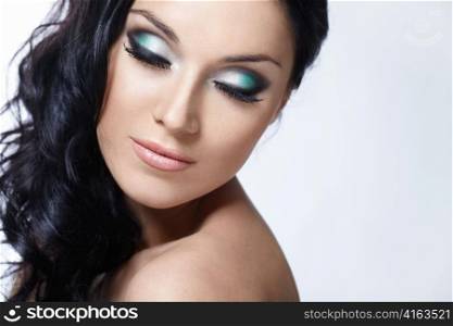 Beautiful girl with make-up with closed eyes on a white background