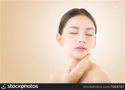 Beautiful girl with makeup, woman and skin care concept / attractive asia girl smilling on face on yellow background.