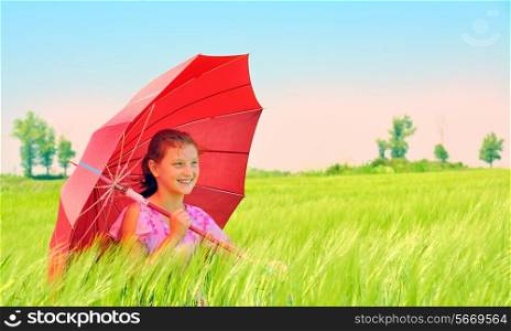 beautiful girl with red umbrella in the green wheat field