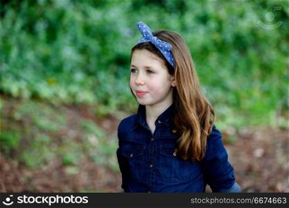 Beautiful girl with ten years old enjoying of a beautiful day. Beautiful girl with ten years old wearing a blue hair scarf enjoying of a beautiful day