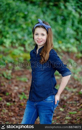 Beautiful girl with ten years old enjoying of a beautiful day. Beautiful girl with ten years old wearing a blue hair scarf enjoying of a beautiful day