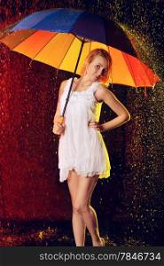 beautiful girl with umbrella under rain, black background
