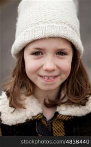 Beautiful girl with wool hat at winter in the street