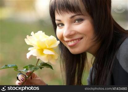 Beautiful girl with yellow rose, sofr background