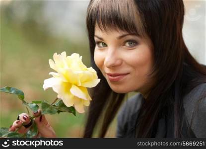 Beautiful girl with yellow rose, soft background