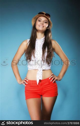 beautiful girl woman long hair in summer clothes and hat having fun. Studio shot on blue. Youth and vacation concept.