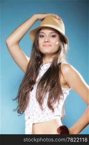 beautiful girl woman long hair in summer clothes and hat having fun. Studio shot on blue. Youth and vacation concept.