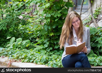 Beautiful girl writing in her journal