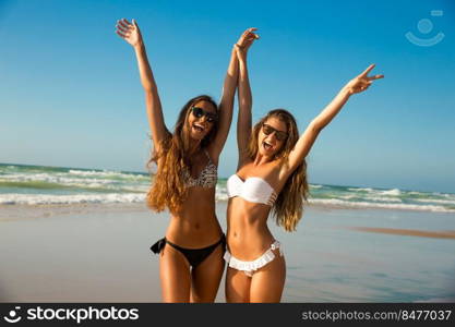 Beautiful girls in a summer day having fun on the beach