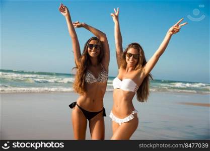 Beautiful girls in a summer day having fun on the beach