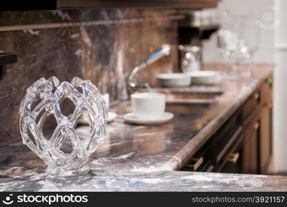 beautiful glass vase on the marble worktop in the kitchen