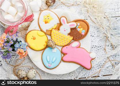Beautiful glazed Easter cookies on wooden table - eggs and bunny close-up. Beautiful glazed Easter cookies
