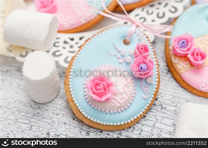 Beautiful glazed Easter cookies on wooden table - eggs close-up. Beautiful glazed Easter cookies