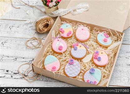 Beautiful glazed Easter cookies on wooden table - eggs in the box. Beautiful glazed Easter cookies