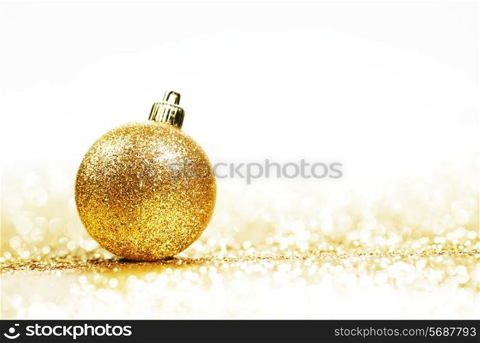 Beautiful Glitter christmas ball close-up on shining background with white copy space