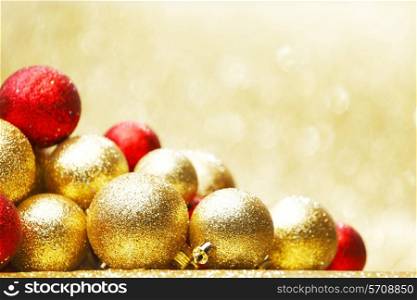 Beautiful Glitter red and golden christmas balls close-up on shining background