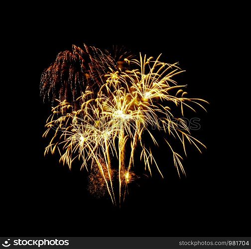 Beautiful Golden fireworks exploding in the night sky, isolated on black background. New year and anniversary concept.