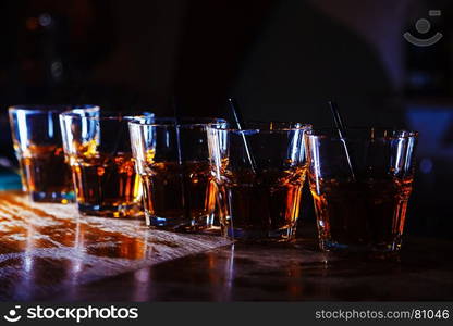 beautiful, golden row of cocktails on the bar